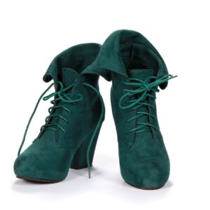 Pair of green suede female shoes isolated on a white background